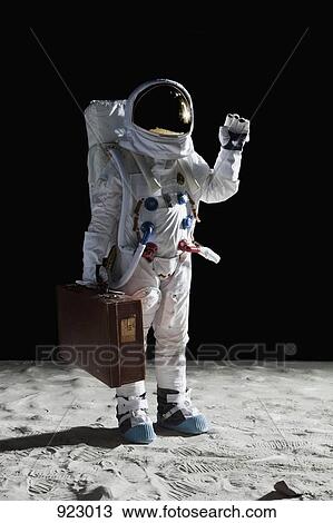 Stock Image - An astronaut on the moon carrying a suitcase and waving. Fotosearch