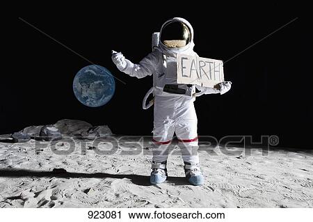 An astronaut on the moon with his thumb out, holding 'EARTH' sign View Large Photo Image Stock Image - An astronaut on the moon with his thumb out, holding 'EARTH' sign. Fotosearch