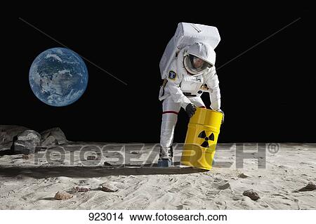 An astronaut rolling a drum of toxic material on the moon surface View Large Photo Image Picture - An astronaut rolling a drum of toxic material on the moon surface. Fotosearch