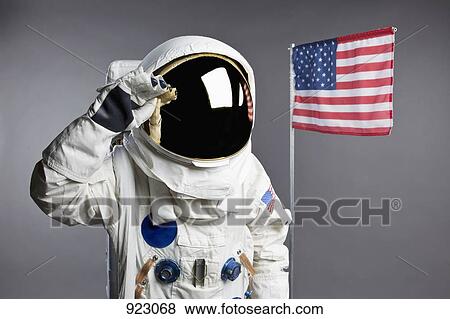 An astronaut saluting next to an American flag, studio shot View Large Photo Image Stock Photo - An astronaut saluting next to an American flag, studio shot. Fotosearch