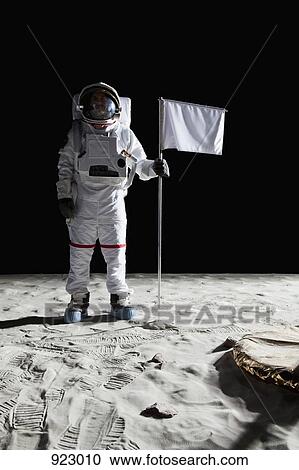 An astronaut standing next to a white flag View Large Photo Image Stock Image - An astronaut standing next to a white flag. Fotosearch