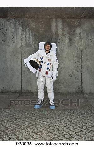 An astronaut standing on a sidewalk in a city View Large Photo Image Stock Photography - An astronaut standing on a sidewalk in a city. Fotosearch