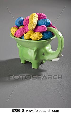 An elephant figurine bowl filled with multi colored peanuts View Large Photo Image Stock Photo - An elephant figurine bowl filled with multi colored peanuts . Fotosearch