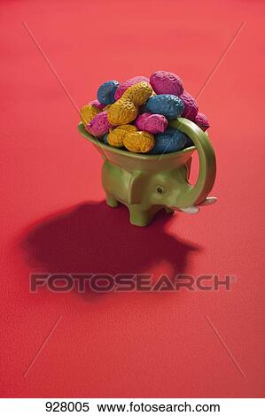 An elephant figurine bowl filled with multi colored peanuts View Large Photo Image Stock Photography - An elephant figurine bowl filled with multi colored peanuts . Fotosearch