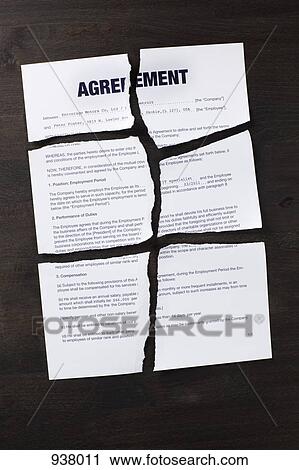 Stock Image - An employment agreement torn into pieces. Fotosearch