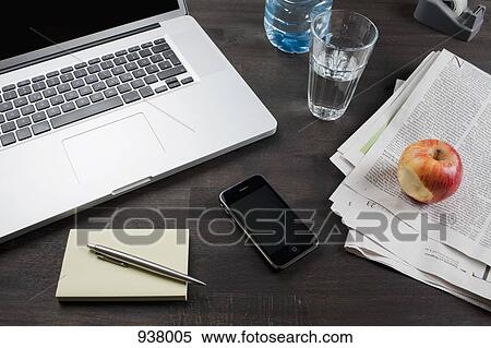 Stock Photography - An office desk with laptop and smart phone. Fotosearch