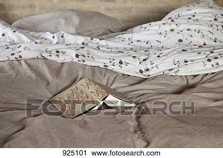 An open book on a bed View Large Photo Image Stock Image - An open book on a bed. Fotosearch