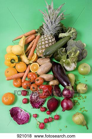 Arrangement of fruits and vegetables on a green background View Large Photo Image Stock Photo - Arrangement of fruits and vegetables on a green background. Fotosearch