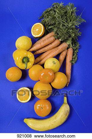 Arrangement of orange and yellow fruits and vegetables on a blue background View Large Photo Image Stock Photo - Arrangement of orange and yellow fruits and vegetables on a blue background. Fotosearch