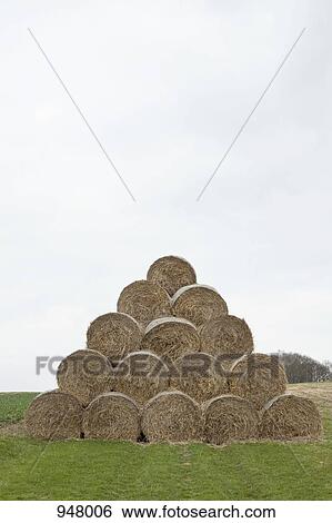 Stock Photograph - Bales of hay arranged in a pyramid. Fotosearch