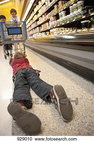 Boys playing with a shopping trolley in a supermarket View Large Photo Image Stock Image - Boys playing with a shopping trolley in a supermarket. Fotosearch