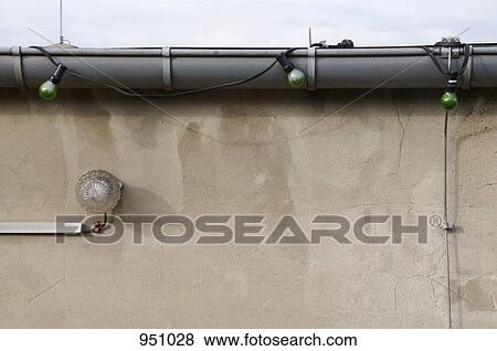 Stock Photo - Close-up of a rain gutter with lights strung on it. Fotosearch