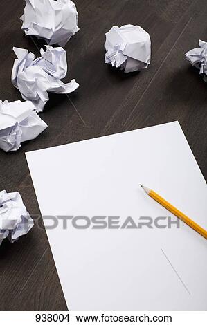 Picture - Crumpled paper balls and a blank piece of paper with a pencil. Fotosearch