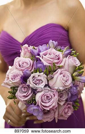 Detail of a bridesmaid holding a bouquet of flowers View Large Photo Image Stock Photo - Detail of a bridesmaid holding a bouquet of flowers. Fotosearch