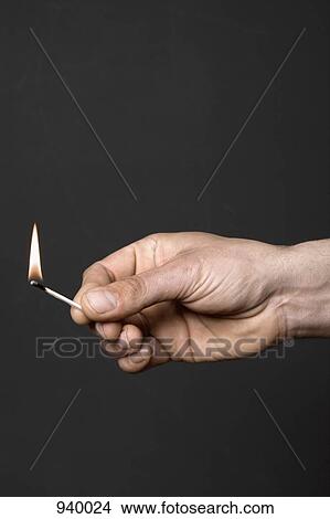 Detail of a man holding a lit match View Large Photo Image Picture - Detail of a man holding a lit match. Fotosearch