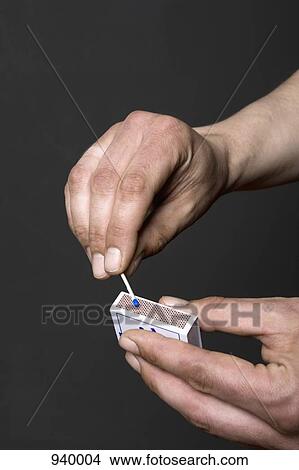 Detail of a man lighting a match View Large Photo Image Picture - Detail of a man lighting a match. Fotosearch