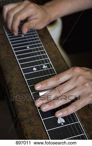 Detail of a man playing a slide guitar View Large Photo Image Stock Image - Detail of a man playing a slide guitar. Fotosearch