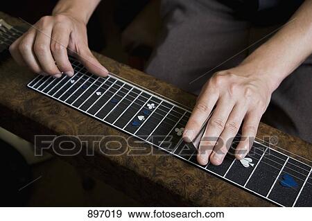 Detail of a man playing a slide guitar View Large Photo Image Stock Photo - Detail of a man playing a slide guitar. Fotosearch