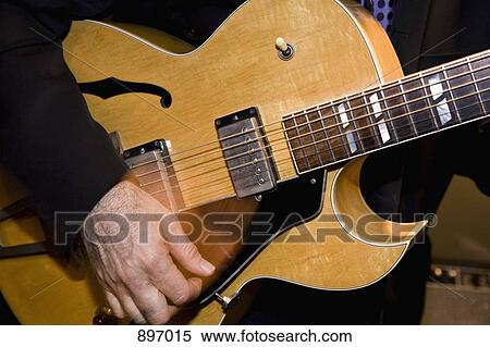Stock Photography - Detail of a man playing an electric guitar. Fotosearch