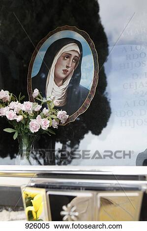 Detail of a mausoleum with a picture of the Virgin Mary and flowers in a vase View Large Photo Image Stock Photography - Detail of a mausoleum with a picture of the Virgin Mary and flowers in a vase. Fotosearch