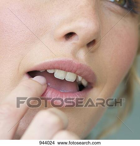 Detail of a woman touching her lip with a finger View Large Photo Image Picture - Detail of a woman touching her lip with a finger. Fotosearch