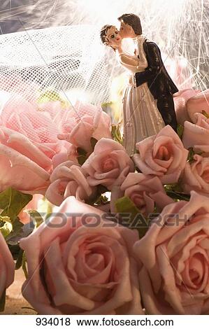 Stock Photo - Detail of roses and a wedding cake figurine . Fotosearch
