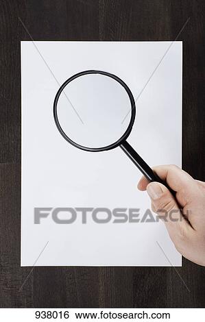 Examining a blank piece of paper View Large Photo Image Stock Photograph - Examining a blank piece of paper. Fotosearch