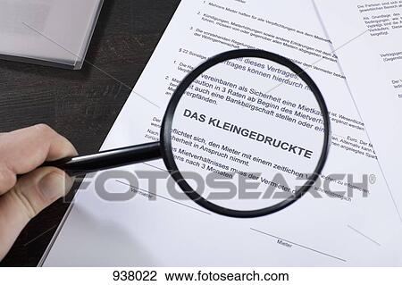 Examining the fine print of a German rental contract with a magnifying glass View Large Photo Image Stock Image - Examining the fine print of a German rental contract with a magnifying glass. Fotosearch