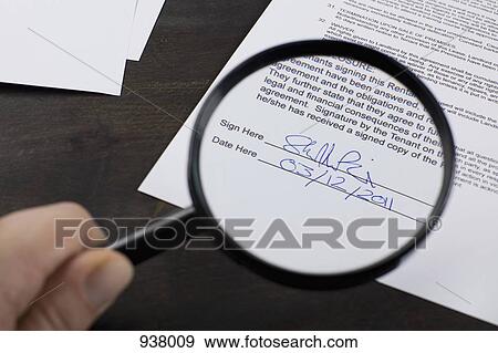 Examining the signature on a rental contract with a magnifying glass View Large Photo Image Stock Photo - Examining the signature on a rental contract with a magnifying glass. Fotosearch