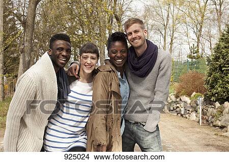 Four friends with their arms around each other View Large Photo Image Picture - Four friends with their arms around each other. Fotosearch