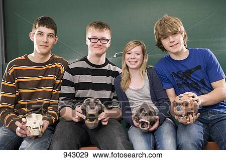 Four students holding primate skulls in biology class, portrait View Large Photo Image Stock Photo - Four students holding primate skulls in biology class, portrait. Fotosearch