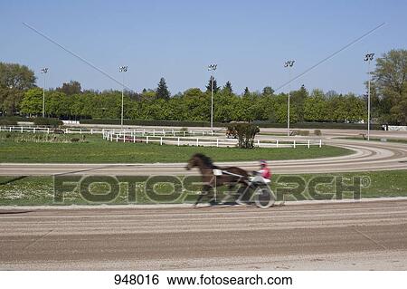 Stock Photograph - Harness racer on a track. Fotosearch