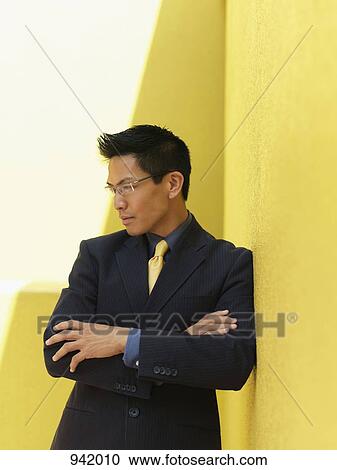 Stock Image - Portrait of a businessman looking contemplative. Fotosearch