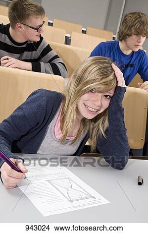 Portrait of a female high school student in class View Large Photo Image Picture - Portrait of a female high school student in class. Fotosearch