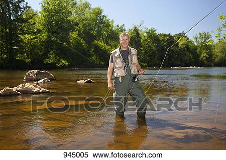 Portrait of a man fly fishing in a river, North Carolina, USA View Large Photo Image Stock Photography - Portrait of a man fly fishing in a river, North Carolina, USA. Fotosearch