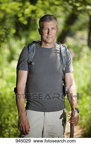 Stock Photo - Portrait of a mature man with a backpack. Fotosearch