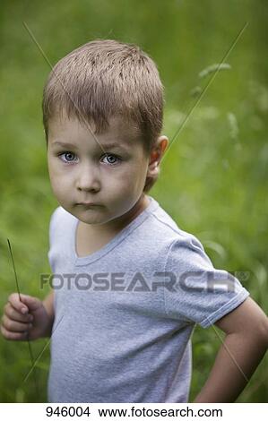 Portrait of a serious young boy View Large Photo Image Picture - Portrait of a serious young boy. Fotosearch