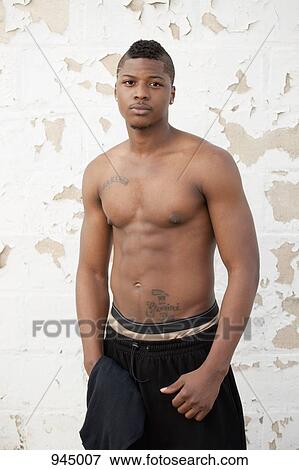 Portrait of a shirtless young man View Large Photo Image Stock Photo - Portrait of a shirtless young man. Fotosearch