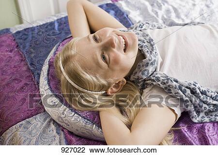 Stock Image - Portrait of a smiling girl looking up. Fotosearch