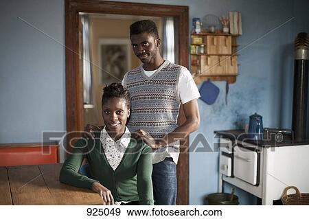 Portrait of a young couple in a domestic kitchen View Large Photo Image Stock Photo - Portrait of a young couple in a domestic kitchen. Fotosearch