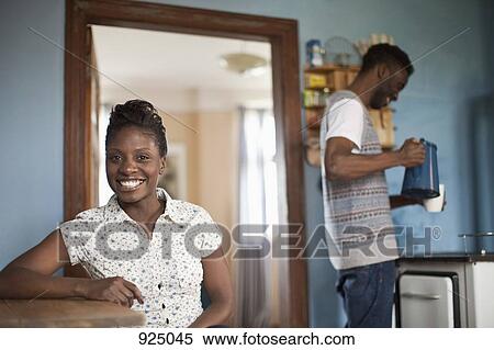 Stock Photography - Portrait of a young woman, young man in background. Fotosearch