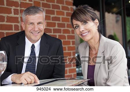 Portrait of two business people at a restaurant View Large Photo Image Picture - Portrait of two business people at a restaurant. Fotosearch