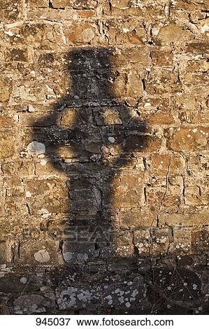 Shadow of a cross on a stone wall View Large Photo Image Stock Photo - Shadow of a cross on a stone wall. Fotosearch