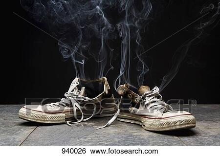 Stock Photograph - Smoke coming from burnt canvas shoes. Fotosearch
