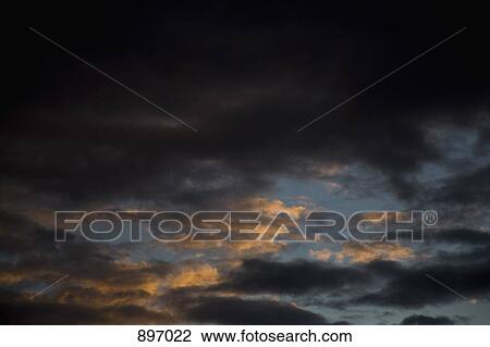Storm clouds in the sky at dusk View Large Photo Image Stock Image - Storm clouds in the sky at dusk. Fotosearch