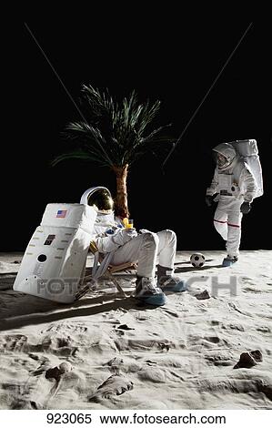 Two astronauts on the moon enjoying some leisure time View Large Photo Image Stock Photography - Two astronauts on the moon enjoying some leisure time. Fotosearch