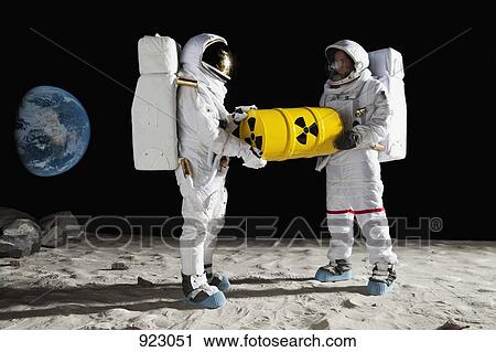 Two astronauts on the moon surface carrying a drum of toxic material View Large Photo Image Stock Image - Two astronauts on the moon surface carrying a drum of toxic material. Fotosearch