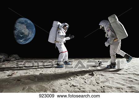 Two astronauts playing soccer on the moon View Large Photo Image Stock Photo - Two astronauts playing soccer on the moon. Fotosearch