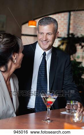 Two business people at a bar View Large Photo Image Stock Photograph - Two business people at a bar. Fotosearch