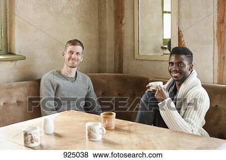 Stock Photo - Two friends sitting at table. Fotosearch